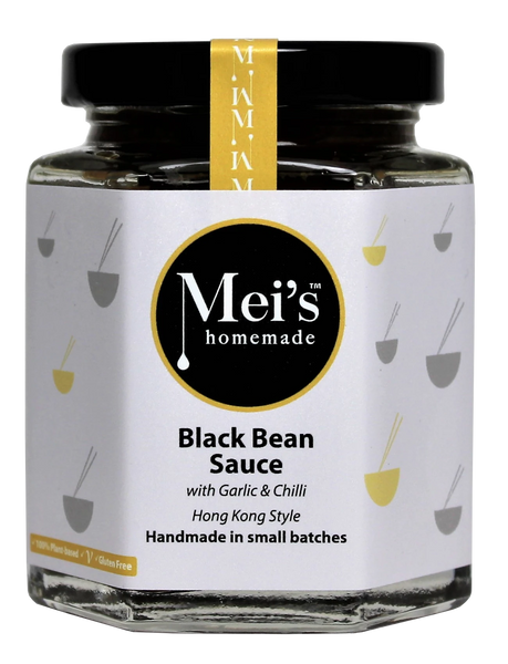 Jar of Mei's homemade black bean sauce with garlic and chili on a white background